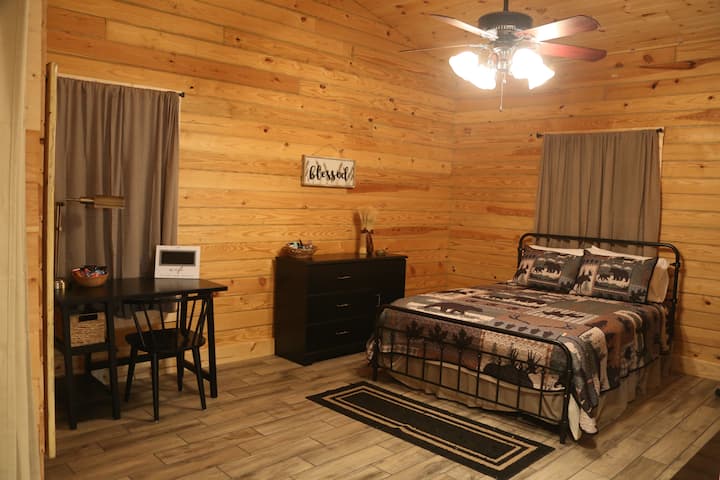 Main cabin - master bedroom with wood fireplace and walk-in closet