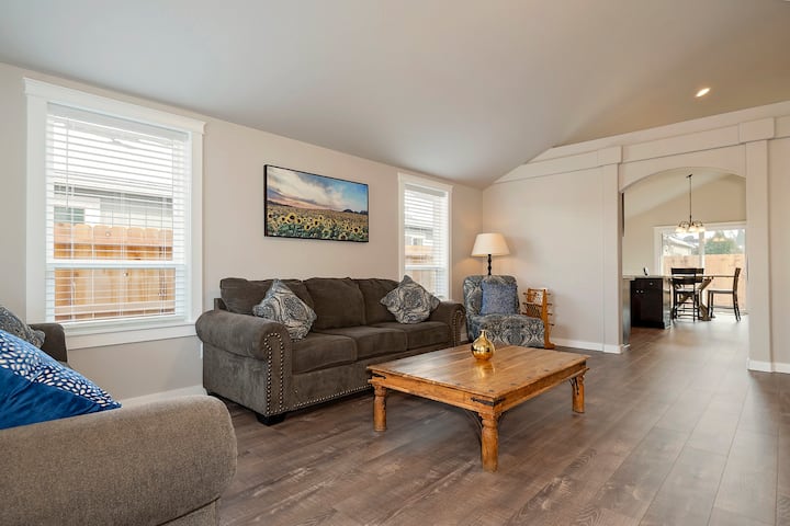 The living room has two comfy sofas with accent pillows, a rustic coffee table to relax and enjoy the 50" flat-screen TV.  
A corner seat allows for a great place to unwind and read a book. The home has a large vaulted ceiling in the main area.