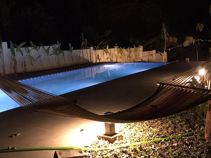 hammock by the brightly lit swimming pool