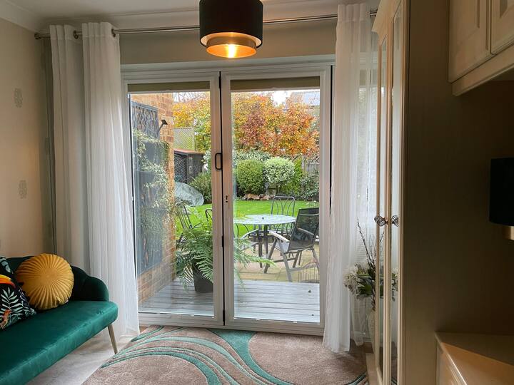 Outlook from the main bedroom with bifold doors onto the garden .