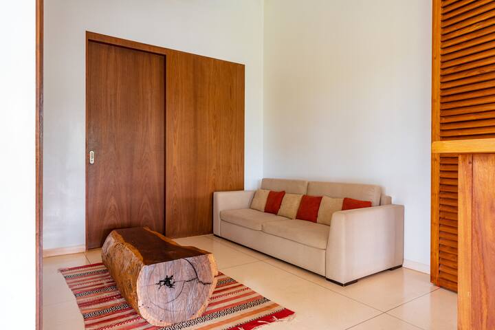 ✨A snug corner featuring a neutral-toned sofa, raw wood log table and rustic rug-perfect for quiet moments and relaxed conversation✨