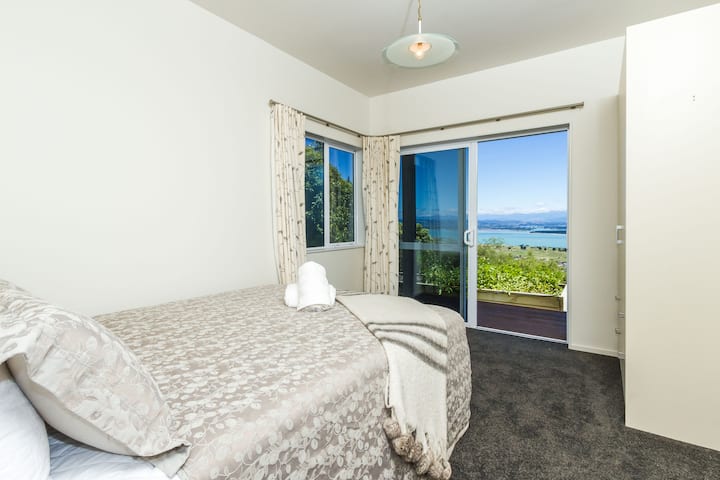 Dormitorio 3 (en la planta baja) con cama tamaño queen y vistas al mar, montaña y jardín.