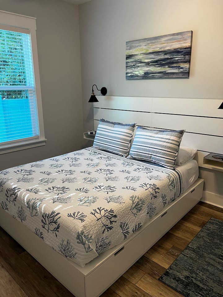 The second bedroom features a queen bed with six storage drawers and a large closet.