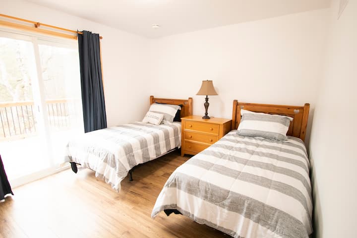 Two twin size beds, with patio door that opens to deck.  The twin beds can be modified to make a King size bed.