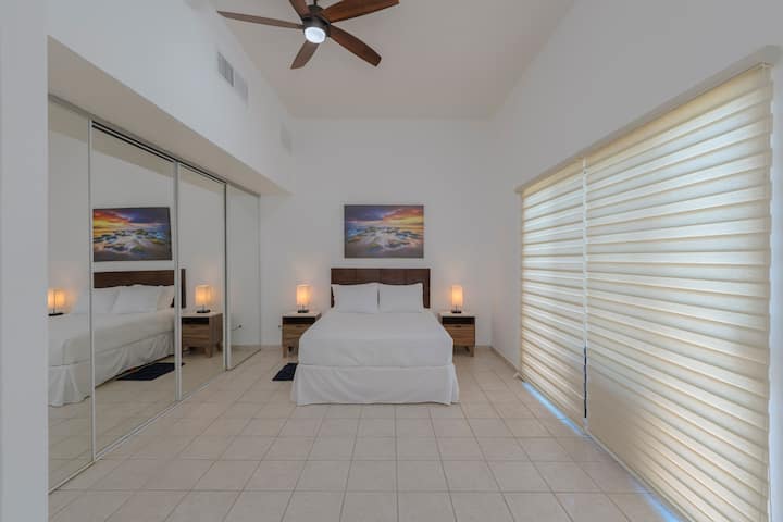 Tercer dormitorio principal con cama tamaño queen y acceso a la piscina