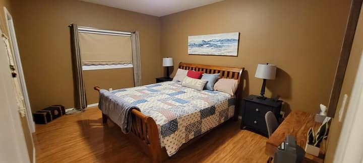 Master bedroom with king bed, desk, ensuite and walk in closet