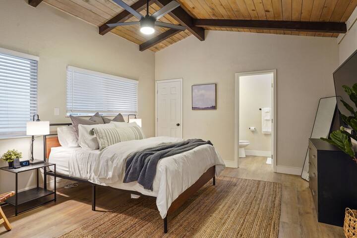 Stunning master bedroom with flat screen television (Apple TV), en suite bathroom, a large closet for storage/clothes hanging, and access to the laundry room are all included in this beautifully decorated and incredibly comfortable space.