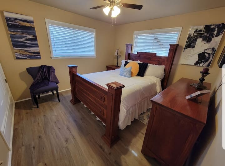 Queen size bed, dresser, night stand w/lamp, corner chair and large built in closet/lower drawers for storage.
