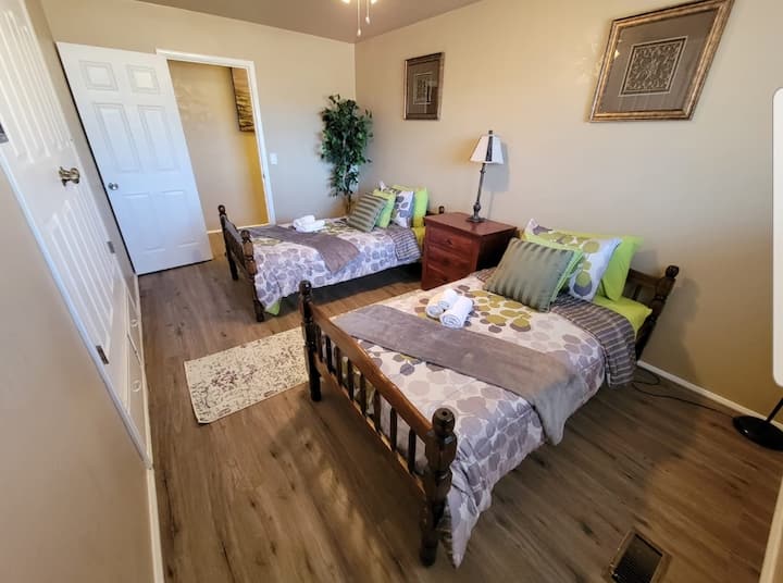 Two twin size beds, night stand w/lamp and large built-in closet with bottom drawers for storage.