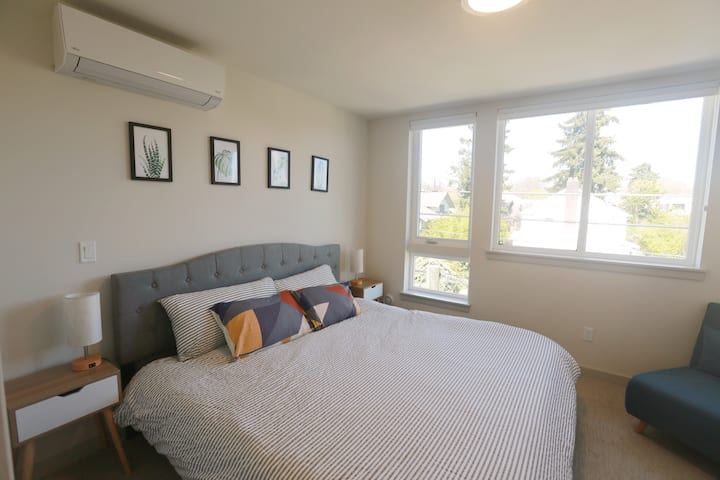 Chambre des maîtres avec un grand lit king size et un canapé-lit.