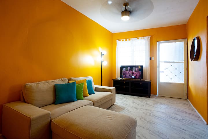 Living room with Roku SmartTV and ceiling fan. 