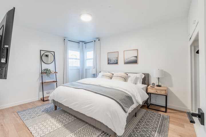 Bedroom #1 has a king bed, 55" flat screen, and plenty of storage with a full closet and dresser. Corner windows with blackout shades, and beach decor.
