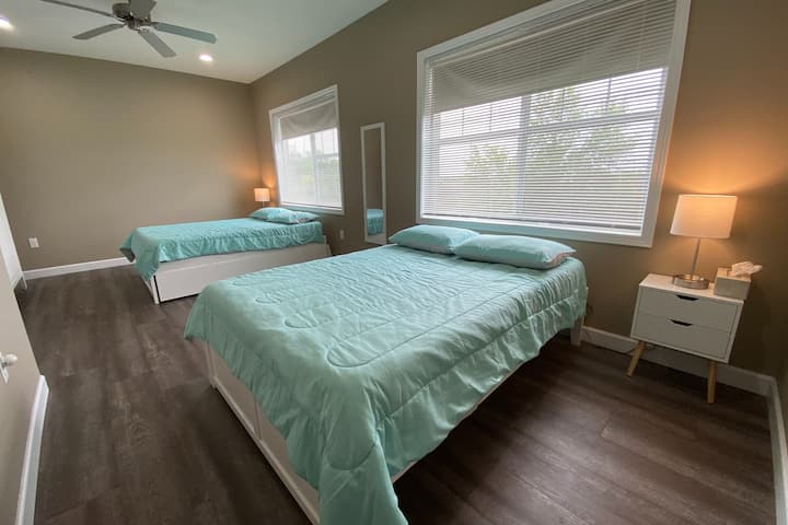 Large guest bedroom featuring 2 full size beds with mattress toppers for added comfort, plus room darkening shades. Each full size bed has a twin size trundle stowed below. Extra pillows and blankets are available.