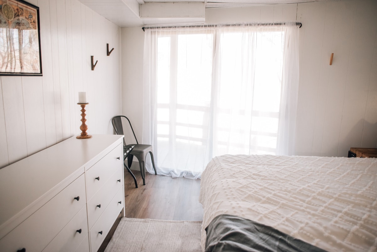 Lower level.  King bedroom with sliding door access to the deck.