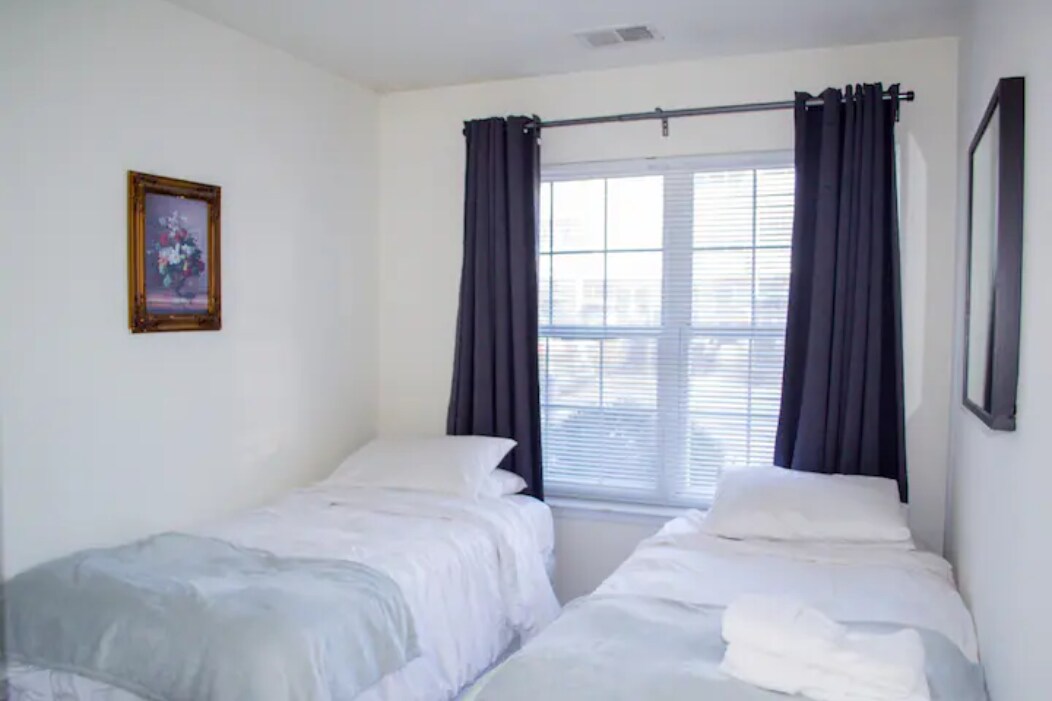 ห้องนอนที่สะดวกสบายพร้อมเตียงเดี่ยวสองเตียง — เหมาะสำหรับเพื่อนร่วมงาน เด็ก หรือสมาชิกทีมที่เข้าพักร่วมกัน การตกแต่งที่เหมาะสำหรับผู้เข้าพักระยะยาวในอพาร์ทเมนท์ 3 ห้องนอนที่กว้างขวางและตกแต่งครบครันในวูดบริดจ์ นิวเจอร์ซีย์