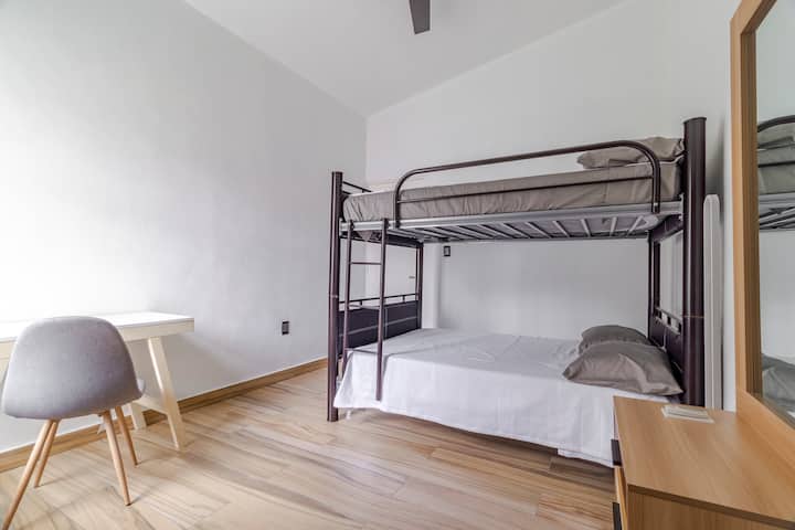 Double room. Double beds. Desk with comfortable chair. Floor lamp. Remote controlled fan. Drawer with full mirror. Closet behind with hangers and themed blankets for extra children.