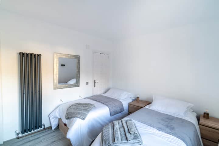 Upstairs bedroom via the spiral staircase in the lounge.  Either two single beds or one super king sized bed.  This bedroom has an en-suite shower room with toilet and wash hand basin, with small wardrobe, chest of drawers and two bedside cabinets.
