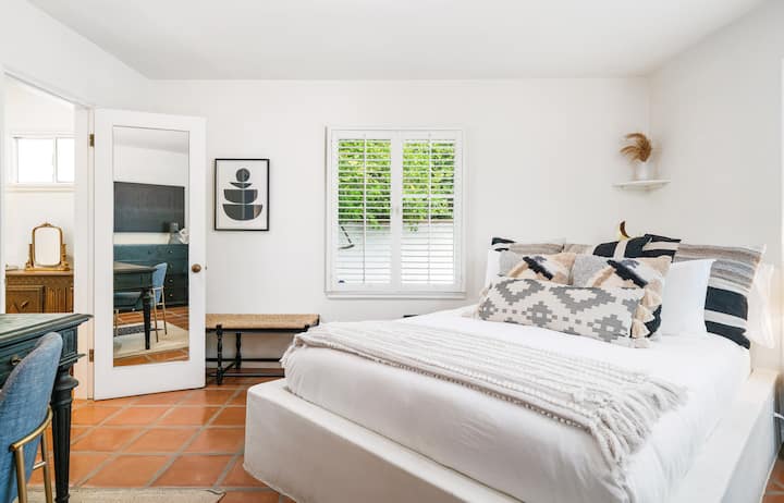 Second bedroom with large built-in king size bed, Windows face the side yard and from private courtyard. Through the door is a closet Area and bathroom with walk in shower