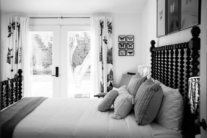 Third bedroom with a queen size bed, French doors facing the backyard and pool