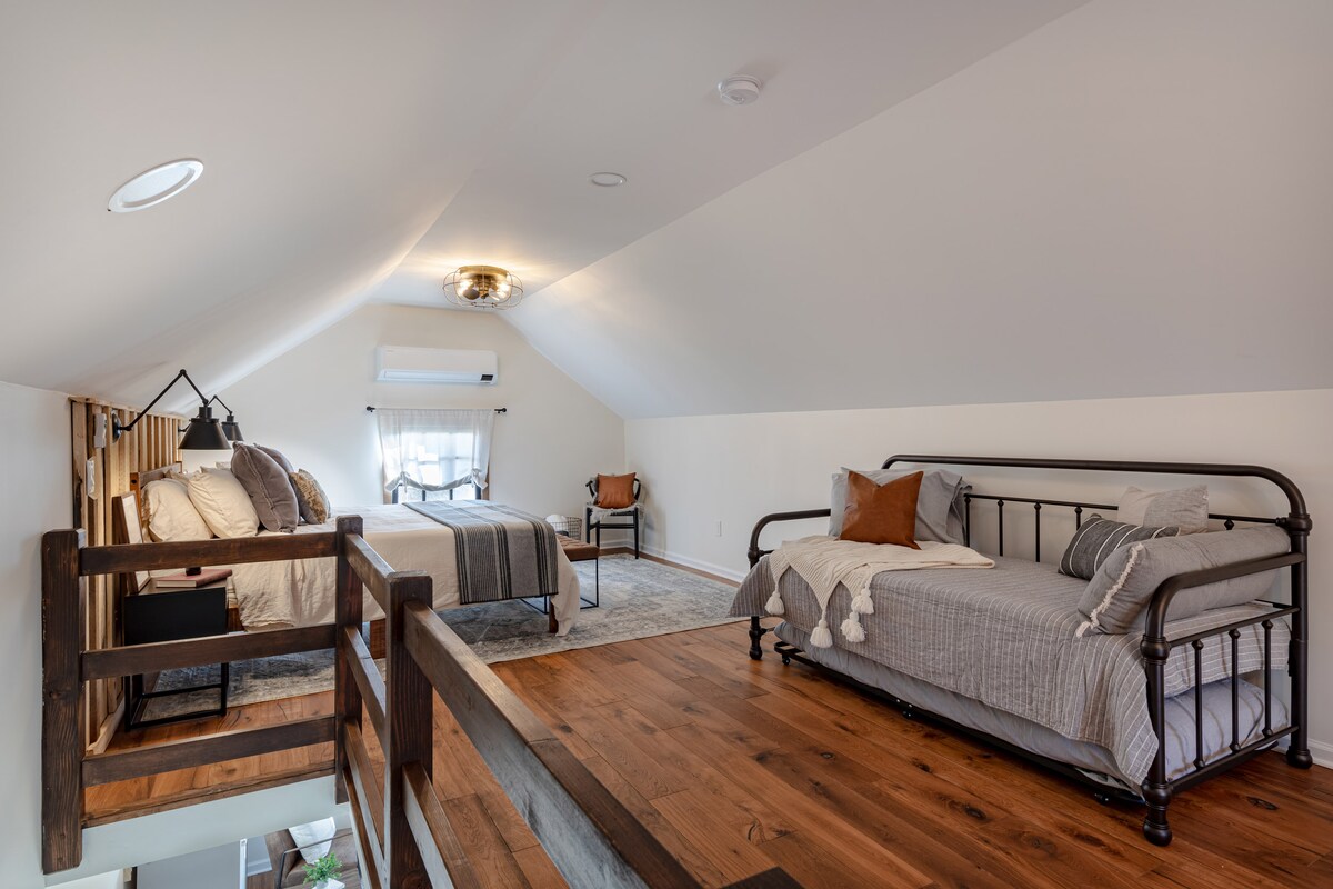 ห้องนอนชั้นบนพร้อมเตียงคิงไซส์และเตียงคู่พร้อมเตียงคู่