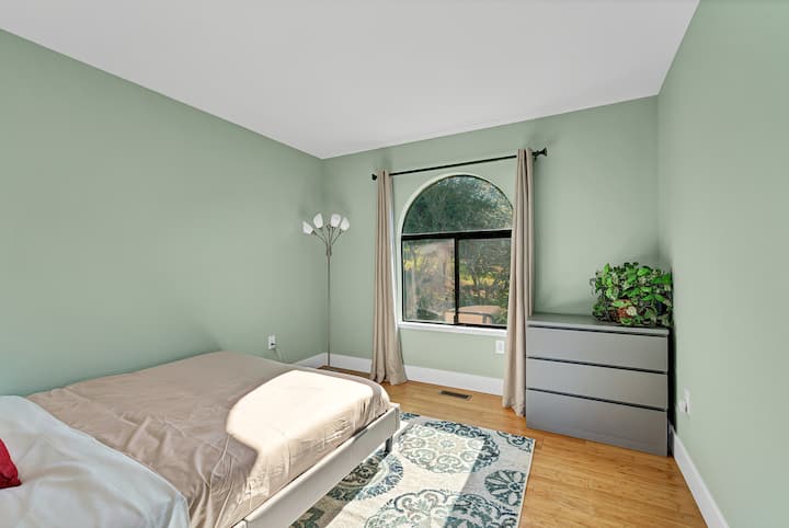 Third bedroom with a queen bed, chest, closet, side table. 