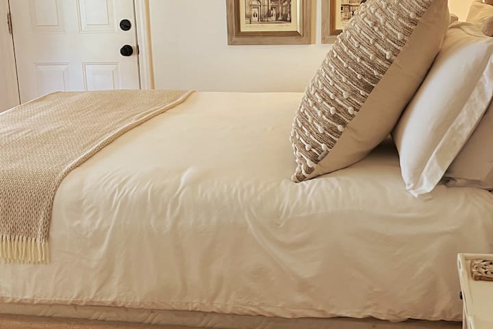 חדר שינה עם מיטת קווין ומצעים יוקרתיים במבוק.