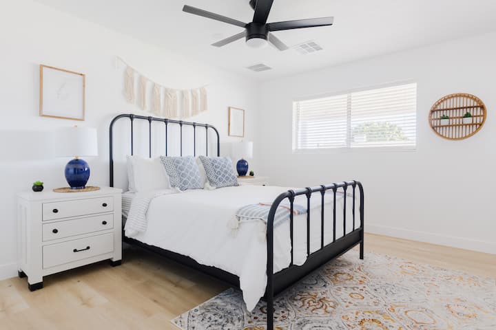 Queen Bedroom #2 with private en suite bathroom which includes a shower, vanity, & toilet.