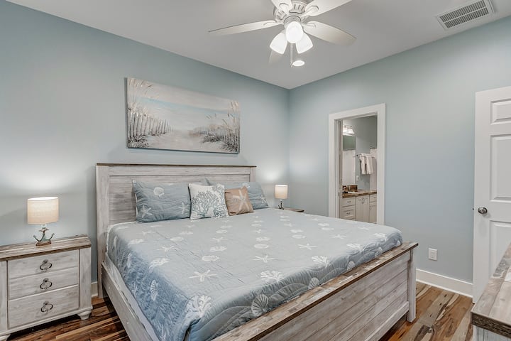 This master bedroom is located off of the living room. It features an en suite bathroom with shower/bathtub combo perfect for kids. The king size bed is ready for you to come in and relax after a long day at the beach. 