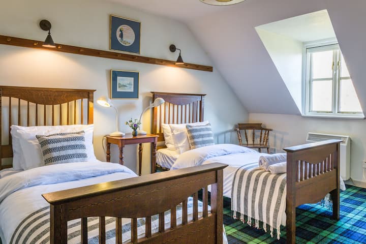 Стая с две единични легла и изглед към морето