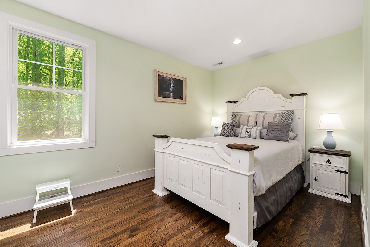 Upper level queen bedroom with view into the woods behind the house