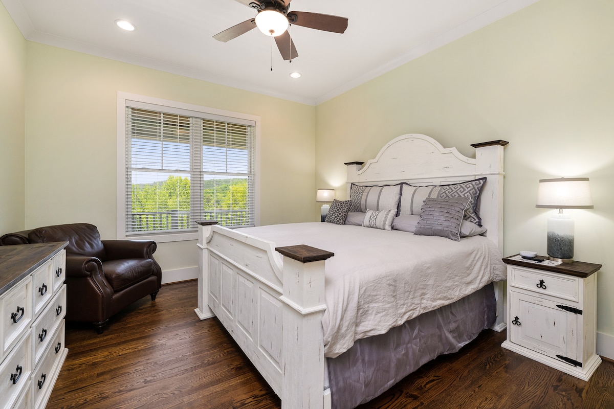 King master suite on main level with a view of the lake