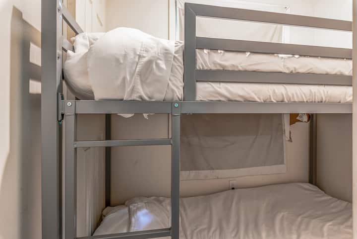 Kids room with bunk bed and blackout curtain (for the parents).