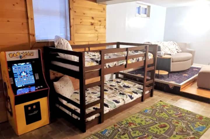 One of our favorite areas in the house! Downstairs you will find games, toys, a couch with a streaming theatre projector, bunk beds (perfect for kids), and an arcade style Pac-Man game!