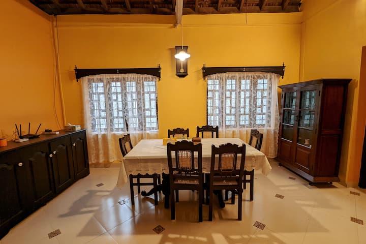 Dining Room furnished with an antique dining table & 4 chairs and single seater sofa.
