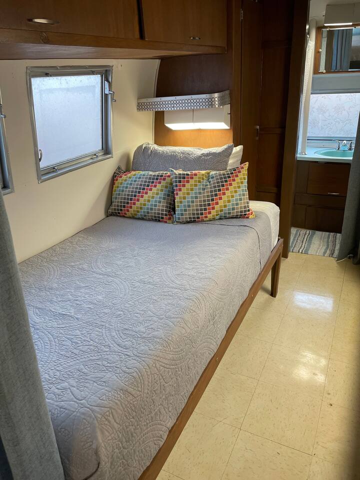Twin bed with overhead lighting. 