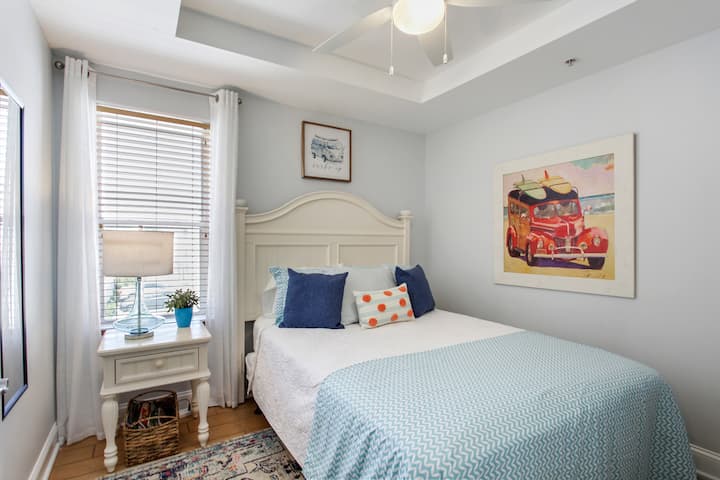 Second bedroom with queen bed and bathroom access.