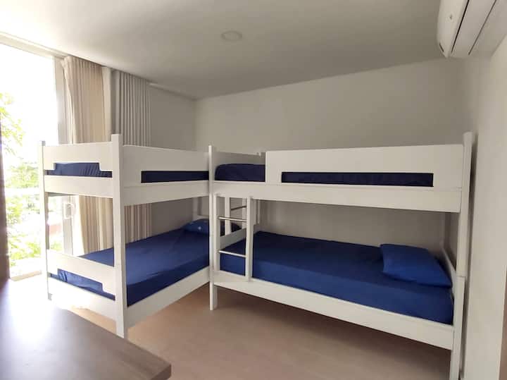 Auxiliary room with two bunk beds, closet, and balcony
