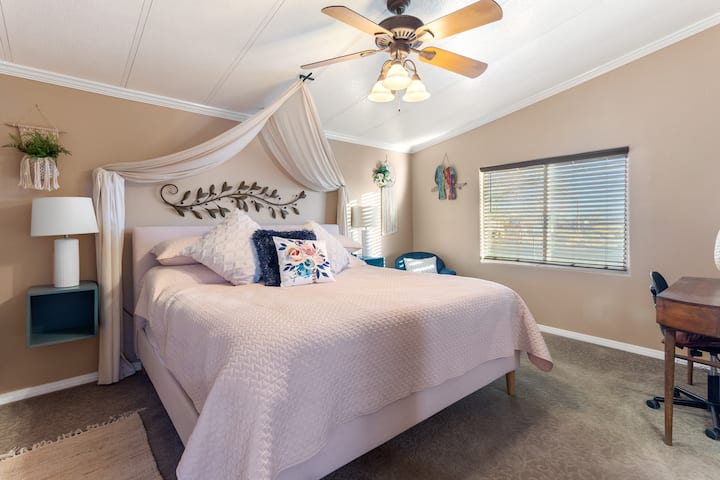 Master Bedroom is a BOHO theme with a king size bed, reading chair and small desk for your working needs.