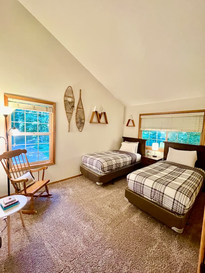 Guest bedroom with two twin beds.  Reading nook with rocking chair.  Pack & play and bedrail in spacious closet. 