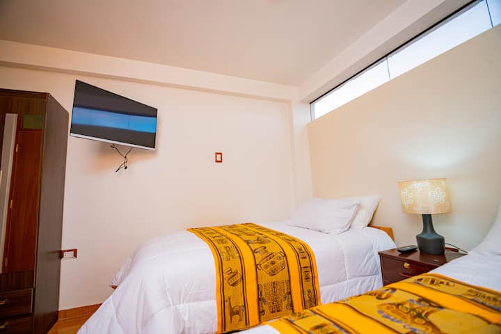 Room No. 04 contains 2 beds and a half, 01 flat screen TV, 01 wardrobe and 01 night sailboat 