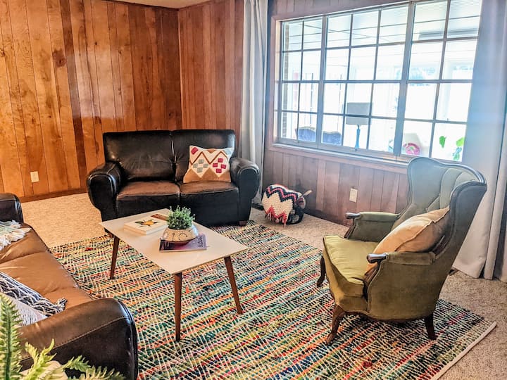 Spacious den gets natural light from the sunroom. 