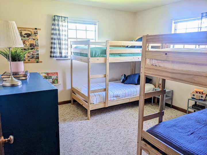 Kids bedroom with two sets of bunk beds, a reading nook and toys. We also have a pack-n-play in the closet. 