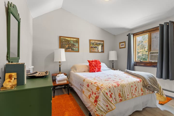 Bedroom 7 is adjacent to an upstairs living room area and has a queen bed.