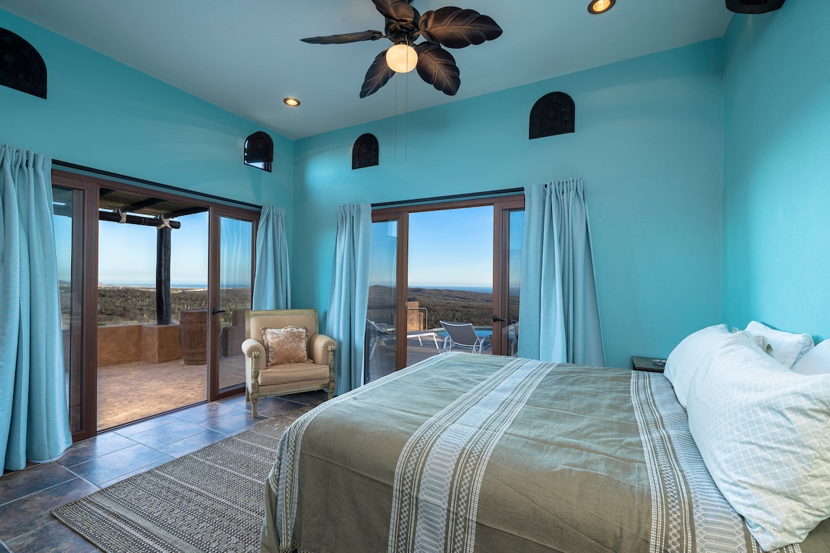 Bedroom 2, king-sized bed with ocean and pool views - outdoor shower is just outside the sliding doors!