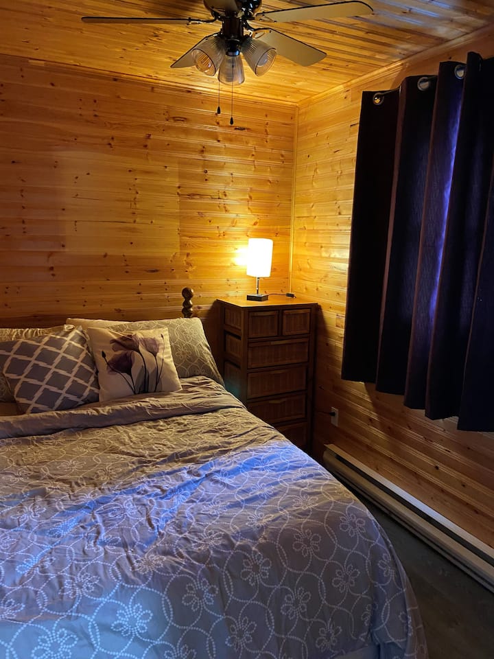 ห้องนอนชั้นล่างพร้อมเตียงควีนไซส์