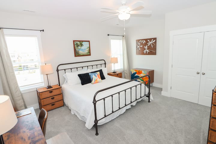 The third bedroom is on the top floor (same floor as the great room and kitchen) and offers a tropical feel with it’s king size bed and Tommy Bahama decor. Includes a dedicated workspace.