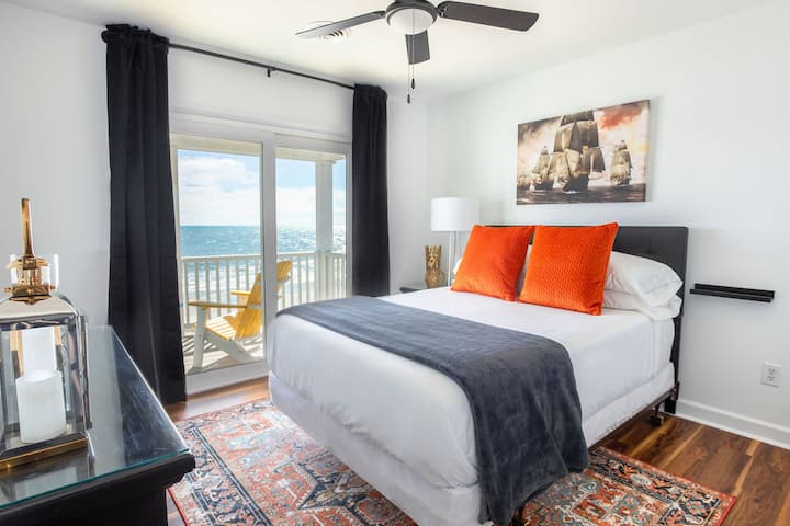 First Mate's Cabin (2nd floor, Southeast bedroom). Drift into slumber while watching the waves, and wake to sunrise breaking over the Atlantic Ocean.  And if you aren't sleepy, slide open the door and sit on the "quarter deck" (2nd floor balcony).