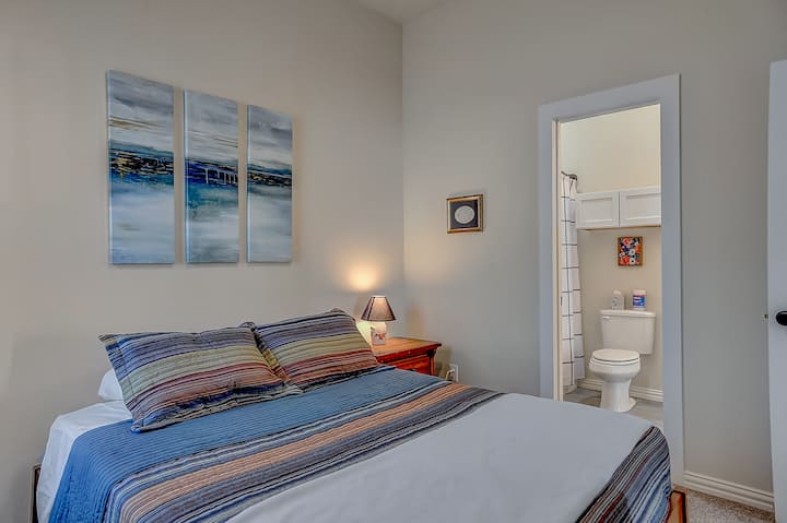 A spacious, cozy  bedroom with a queen bed and attached bathroom!