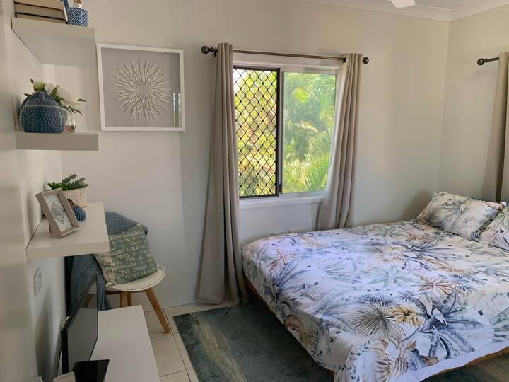 Beautiful soft beach theme flows into this beautiful decorate bedroom. 

Large mirrored wardrobe with plenty of hanging and shelf space. 

A comfy Queen size bed awaits you with views overlooking the pool and back garden. 