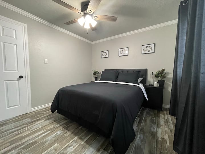 Queen bedroom; nightstands include USB charging ports.